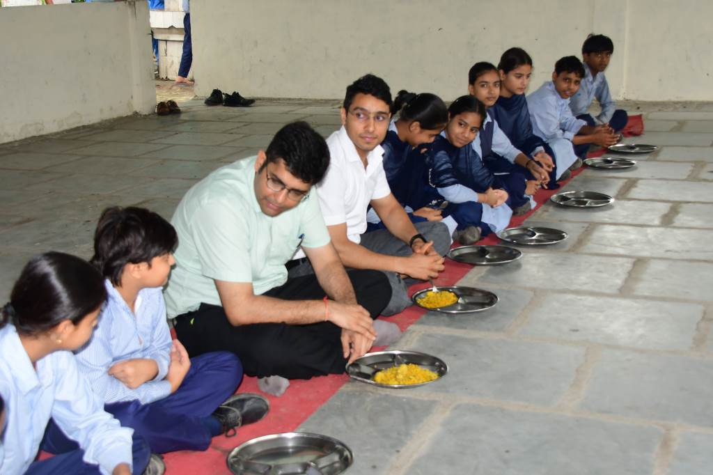 DC inspects midday meal by sitting with students at a government school
